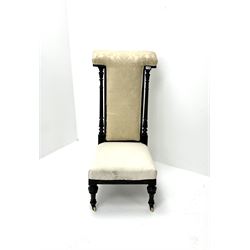Victorian ebonised prie dieu chair upholstered in an ivory ground fabric, turned reeded and tapering supports