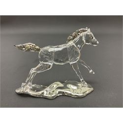 Five Swarovski Crystal horses, comprising stallion, rearing horse, pair of horses playing and Arabian stallion, each with frosted manes and tails, together with a small Swarovski Crystal galloping horse, the mane, tail and base with smoky tint