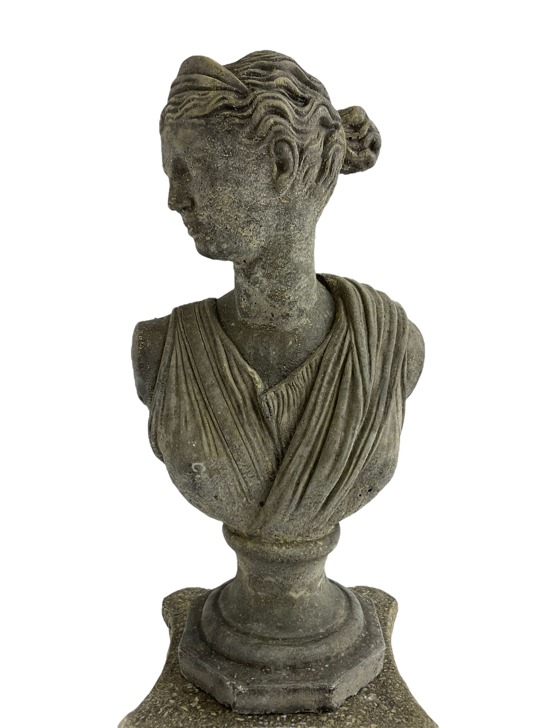Classical design cast stone female bust depicting Artemis, raised on fluted Corinthian column with acanthus leaf capital, stepped square base, looking right 