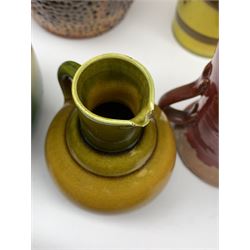 Pair of early 20th century yellow glaze cylindrical vases with floral decoration, H29cm, various Bretby circular planters, small Bretby bottle vase with drip glaze, pair of three-handled vases and other similar pottery 