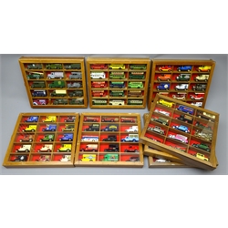  Set of eight wall hanging hardwood display cases for die-cast models each with glazed door enclosing fifteen divisions containing  Lledo Days Gone and promotional vehicles including military, buses, trams etc, all unboxed, 29x33cm (8)  