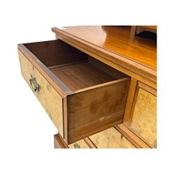 Victorian walnut bedroom suite - wardrobe, dressing chest and bedside cupboard, comprising a full-length wardrobe with broken pediment and central mirrored door, large lower drawer, a matching dressing table with bevelled swing mirror over two trinket drawers and two short drawers over two long drawers, and a single-door bedside cupboard, all with moulded edges, decorative panel work and shaped aprons