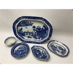 A late 18th century Caughley Salopian dessert dish decorated in the Caughley Willow pattern with a willow type landscape containing two figures in conversation within a white reserve, with printed marks verso, L26.5cm, together with a later dish decorated in a similar pattern, D23.5cm, a 19th century blue and white platter decorated in the Long Bridge pattern, L51.5cm, and two further pieces of blue and white.