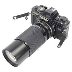 Two Minolta SLR camera bodies, comprising X-300 serial no. 8592491 and X-700 serial no. 1498583, together with five lenses including Sigma Telephoto 1:5.6 f=400mm serial no. 1018435, Vivitar Series 1 28mm 1:1.9 VMC Auto Wide Angle Lens no. 37822044, two Minolta MD 50mm 1:1.7 49mm lens nos. 7177581 & 8384472, Tamron 70-210mm 1:3.8-4 lens no. 8316867 and camera accessories, all within a soft carry case