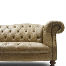Tetrad - 'Matisse' grande three-seat sofa, Chesterfield shape with rolled arms flanking a serpentine back and front, upholstered in buttoned tan leather with close-nailed studwork, on turned feet