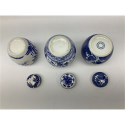 Six Chinese ginger jars, predominantly of blue and white design decorated with blossoming branches, all with lids, housed on various hardwood carved stands, some with character marks beneath