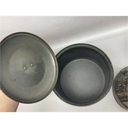 Four Victorian copper moulds, together with a graduating set of copper pans with wooden handles and finials to covers, largest pan 