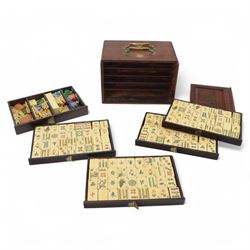 20th century Chinese Mahjong set, with five drawers containing bone counters and tiles, contained within a wooden box with brass detailing, together with a set of eight wooden Mahjong tile trays