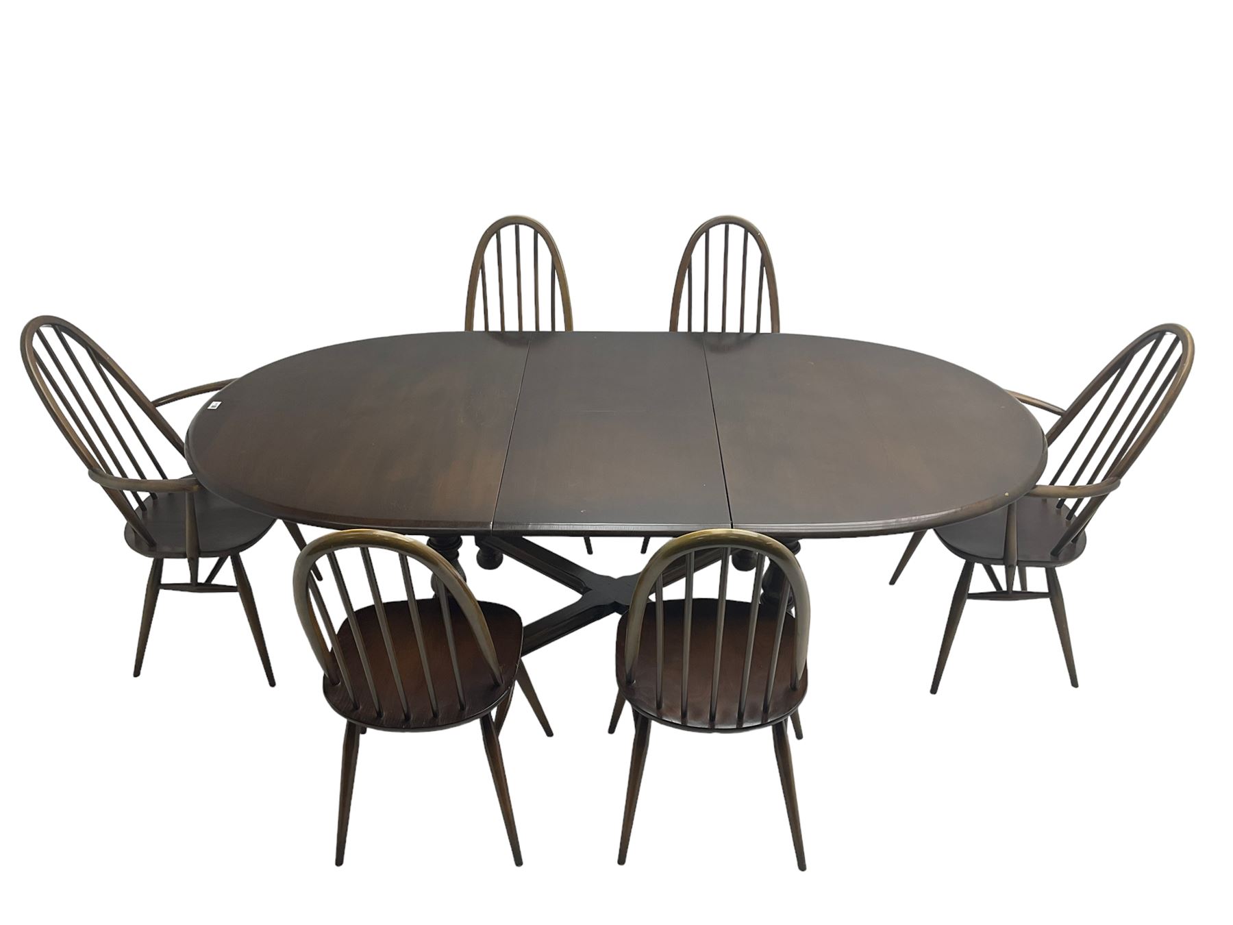 Ercol - 'Old Colonial' 705 elm extending dining table, oval top with hidden leaf, raised on turned supports united by X-stretcher (W163cm D108cm H72cm); and Ercol - set six  (4+2) dark elm 'Quaker Back Windsor Dining Chairs', hoop and stick backs 