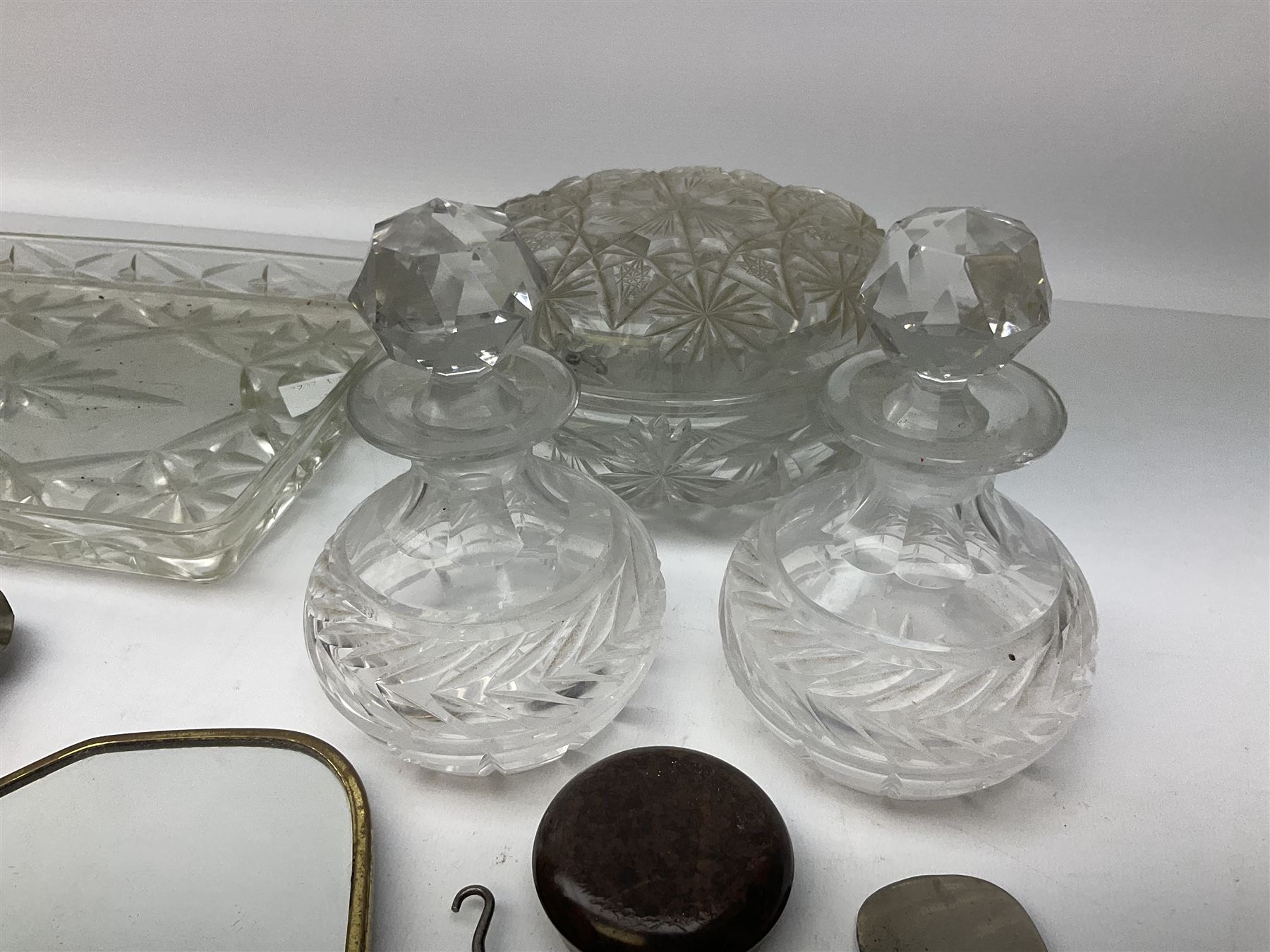 Glass dressing table tray, scent bottles and lidded bowl, metal mounted foliate design hair brushes and handheld mirrors etc