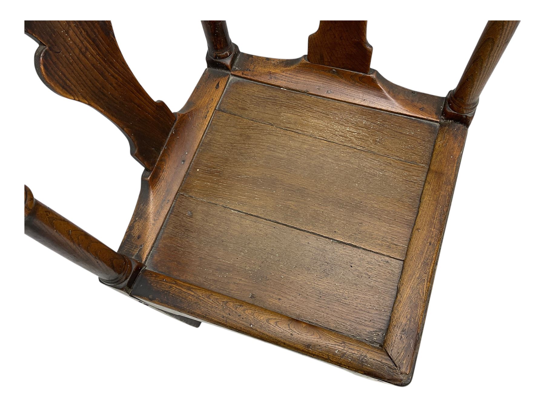 18th century oak corner elbow chair, the shaped cresting rail terminating to swept arm rests, supported by turned columns and vase-shaped splats, over square plank seat, raised on square-section supports