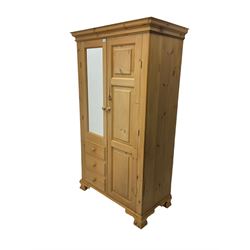 Pine double wardrobe, moulded cornice over single mirror front door over three drawers and opposing panelled door, on ogee feet