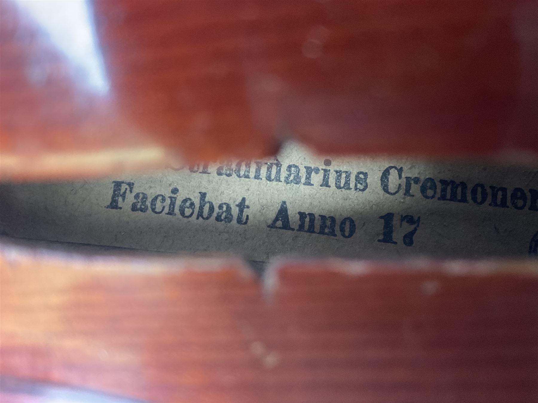 Late 19th century French three-quarter size 'Conservatory' violin with 34cm two-piece maple back and ribs and spruce top, the peg box inscribed 'Conservatory Violin Straduari', bears label 'Antonius Stradiuarius Cremonensis Faciebat Anno 1721' L55.5cm overall; in ebonised wooden 'coffin' case; and Saxony violin c1900 with 36cm two-piece maple back and ribs and spruce top; bears label 'Antonius Stradivarius Cremonensis Faciebat Anno 17**' L59cm overall; in carrying case (2)