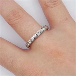 Early-mid 20th century platinum channel set diamond full eternity ring, the band with engraved decoration, total diamond weight approx 0.90 carat