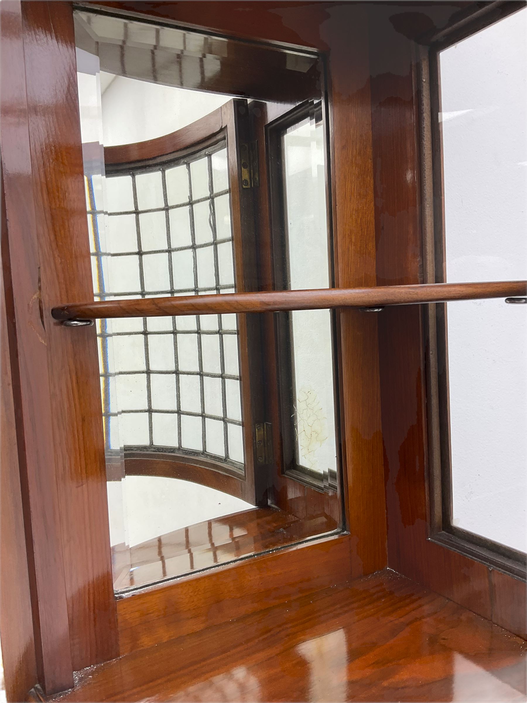 Late Victorian walnut mirror back sideboard or dresser, the raised back fitted with two curved and lead glazed cabinets, central arched bevelled mirror, the sideboard with break bowfront, fitted with six drawers and two cupboards, the cupboard doors panelled and carved with scrolls, shell and plant motifs, shaped apron with cabriole feet
