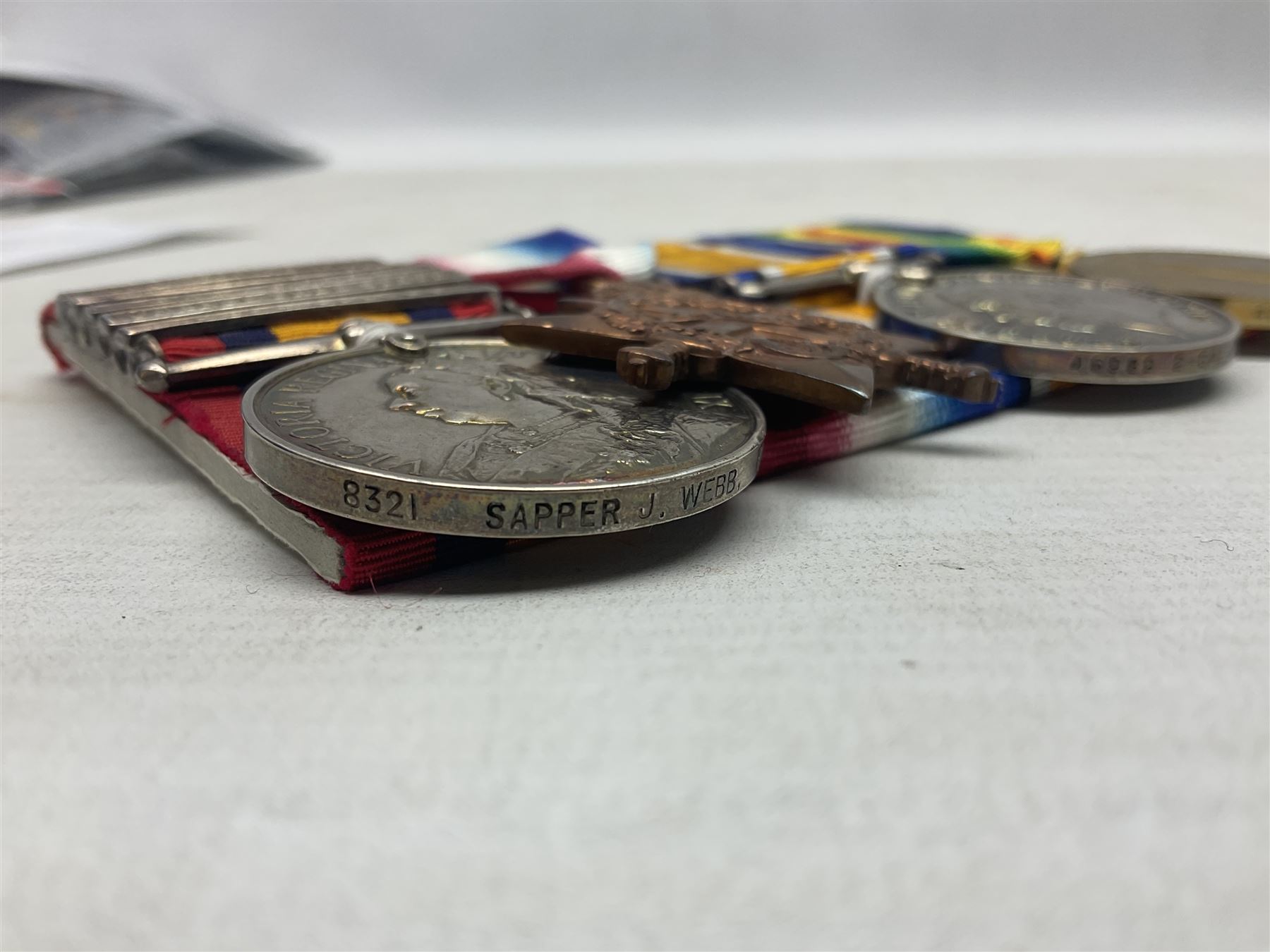 Boer War/WW1 group of four medals comprising Queens South Africa Medal with five clasps for South Africa 1901 & 1902, Transvaal. Orange Free State and Cape Colony awarded to 8321 Sapper J. Webb Rl. Engrs.; together with British War Medal, 1914-15 Star and Victory Medal awarded to 46989 2.Cpl. J. Webb R.E.; all with ribbons and mounted for display on card; some biographical details