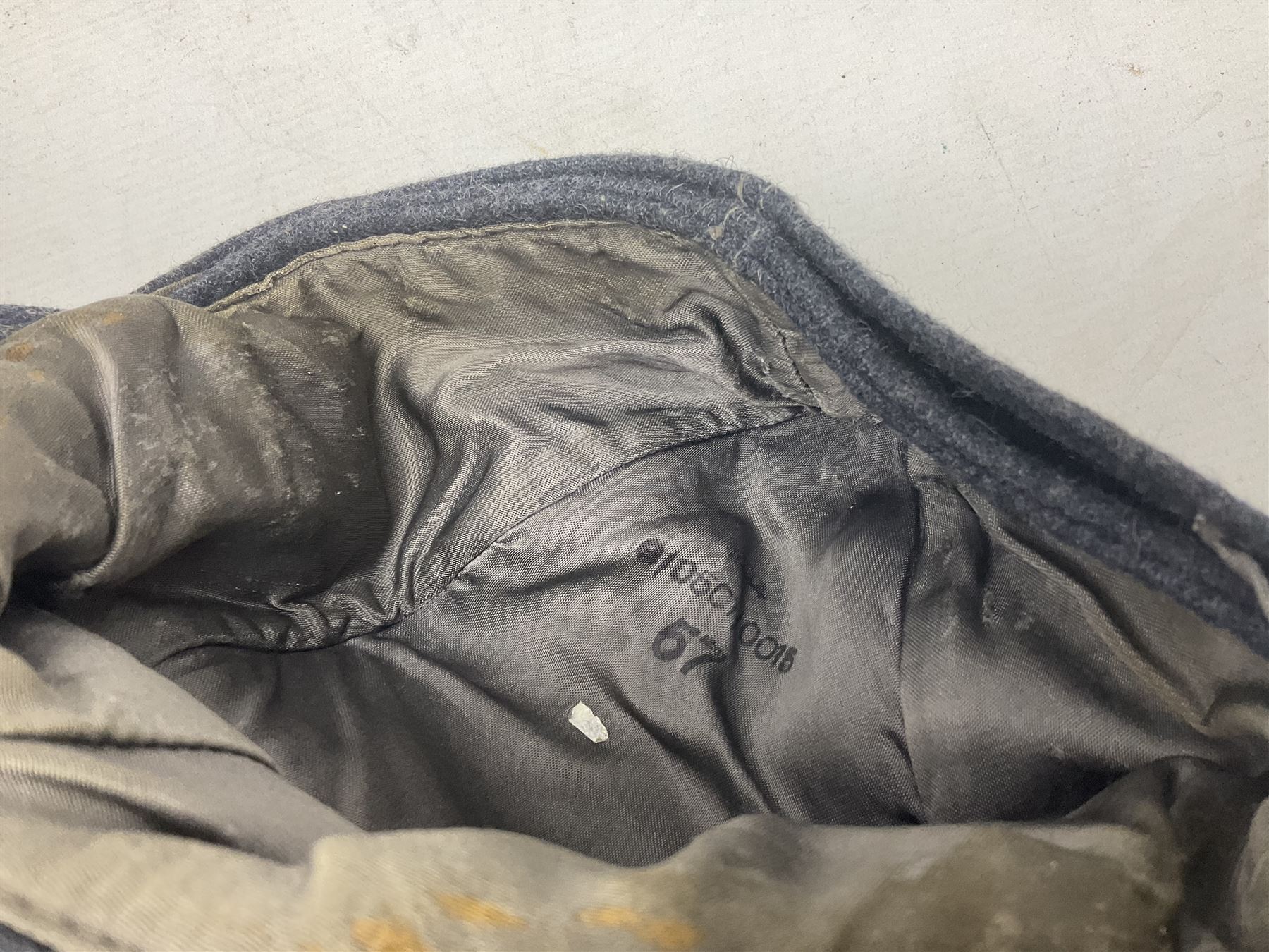 WW2 German Luftwaffe M43 field cap with triangular cloth eagle and roundel badge; marked '1944 ?/0501/0015 57'