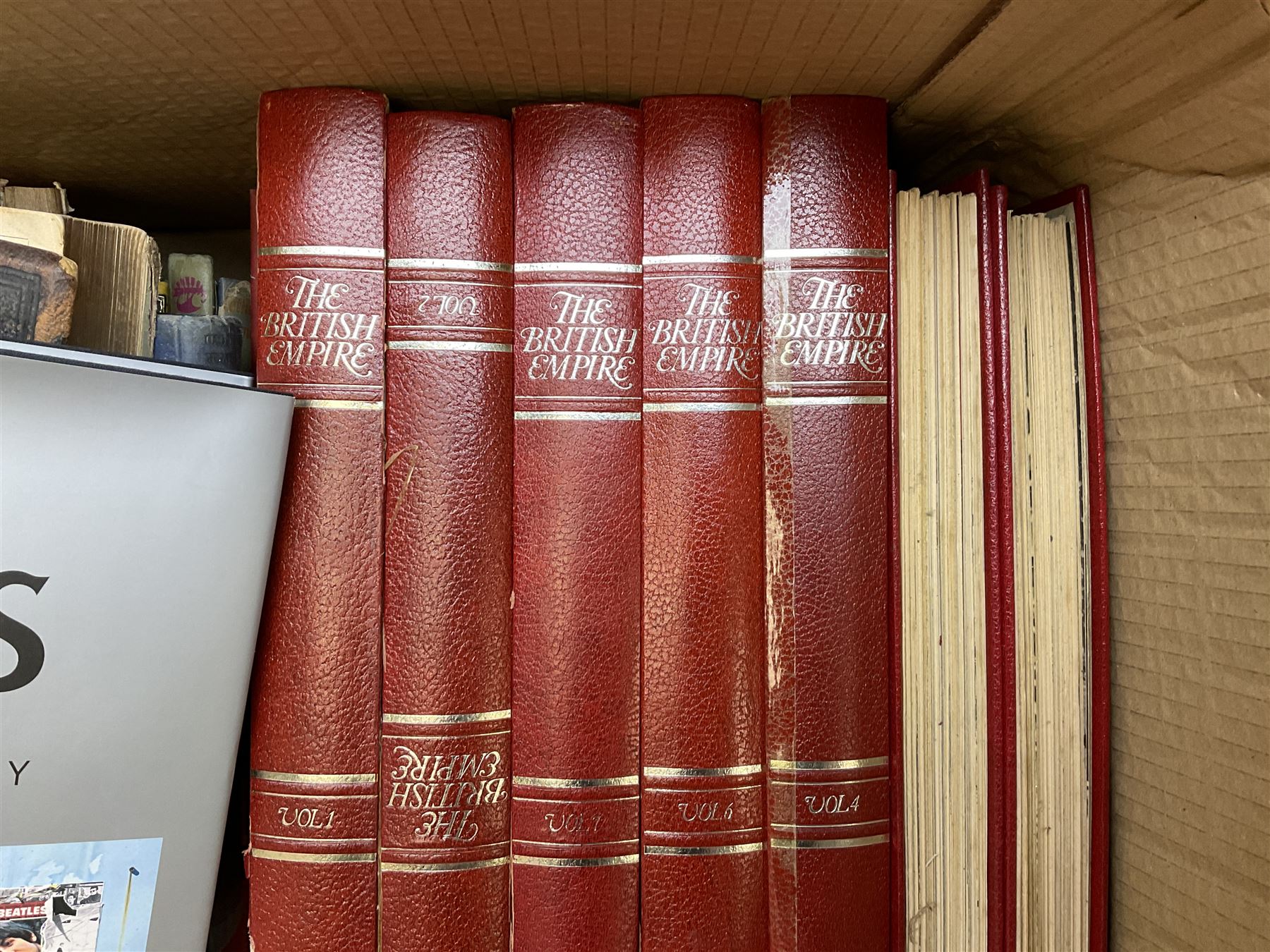 Quantity of books to include The Beatles Anthology hardback, published 2000, leather effect bound The British Empire volumes, The Times Atlas of the World, and other books to include the Bible etc