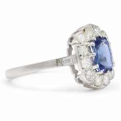 Platinum sapphire an diamond cluster ring, single modified cushion cut sapphire of approx 1.40 carat, surrounded by milgrain set round brilliant cut diamonds and baguette diamond shoulders, hallmarked, total diamond weight approx 0.80 carat