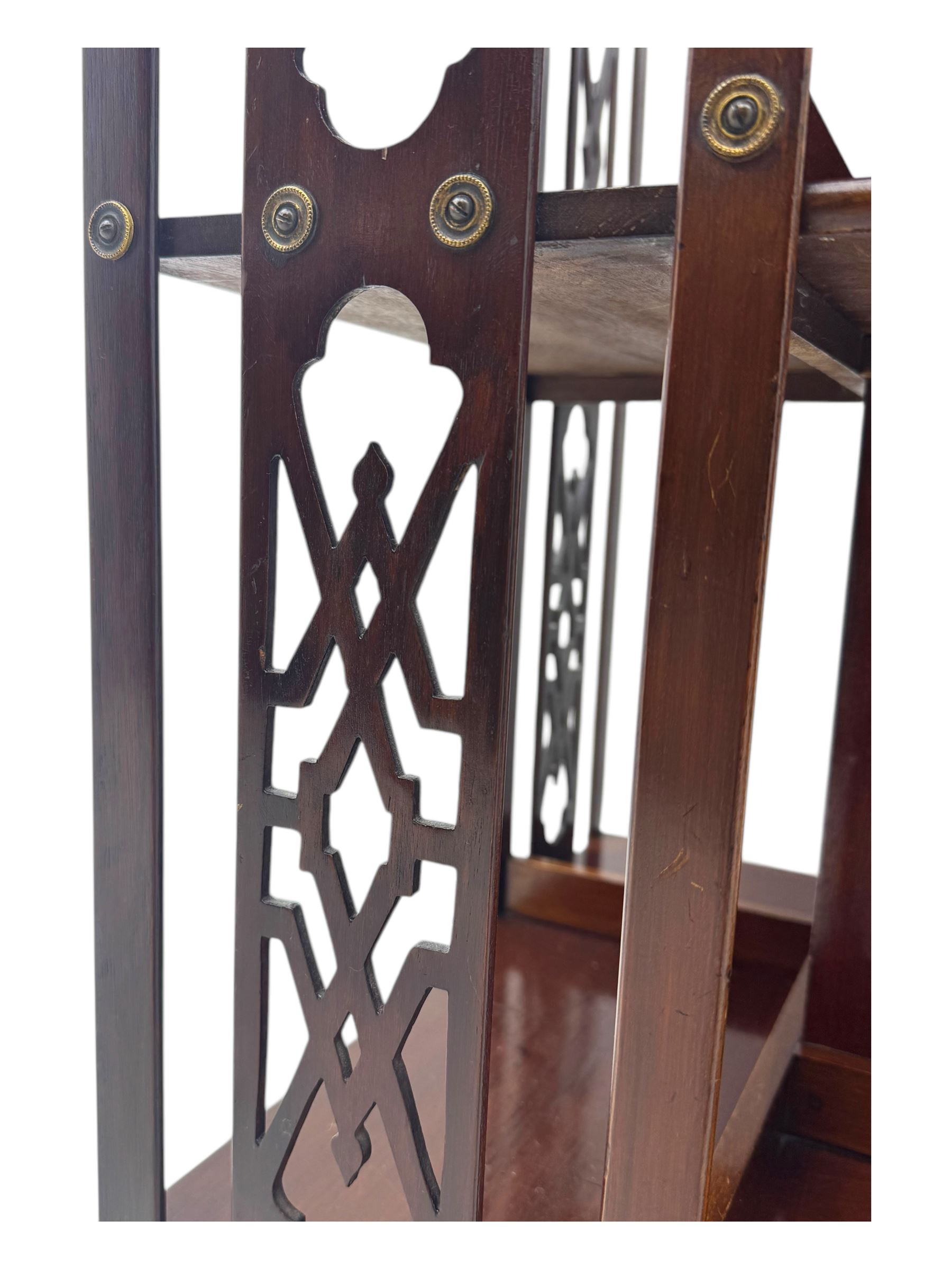 Edwardian inlaid mahogany revolving bookcase, shaped square moulded top with central motif and satinwood band, two tiers with pierced vertical splats, on swivel action base with ceramic castors