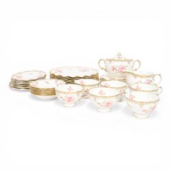 Modern Royal Crown Derby tea set for six place settings, decorated in the Royal Pinxton Roses pattern, comprising tea cups, saucers, small dishes, side plates, dessert plates, one serving plate, twin handled lidded sucrier and milk jug