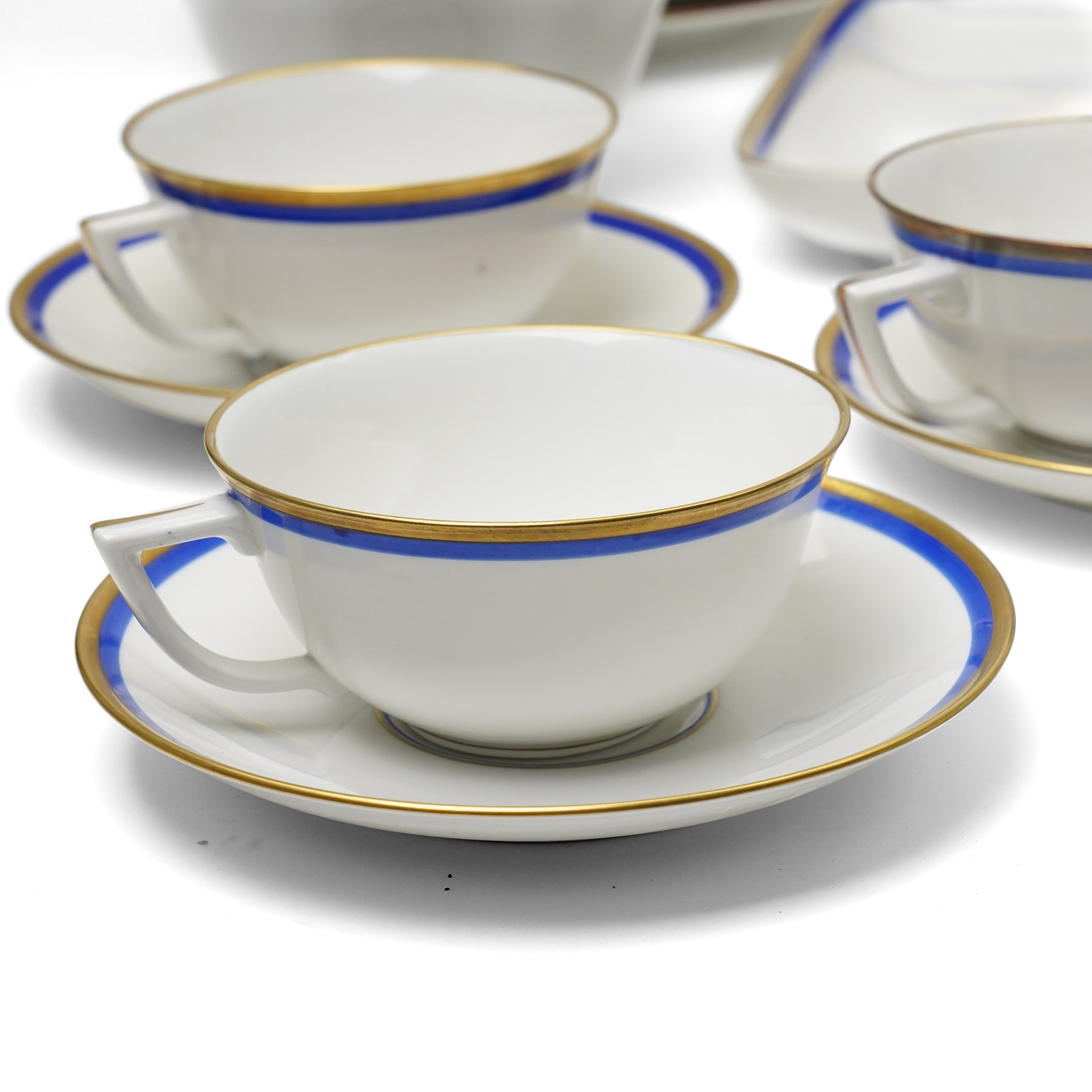 Royal Copenhagen mid-20th century tea service decorated in blue and gilt comprising ten teacups, ten saucers, ten side plates, two triangular serving plates, two square serving plates, teapot, milk jug and covered sucrier 