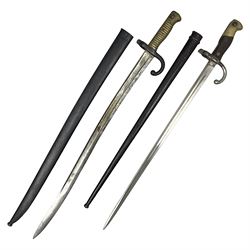 French Model 1866 Chassepot bayonet with 57cm curving fullered steel blade dated 1873 No.L63963; in steel scabbard with conforming number L71.5cm overall; and French St. Etienne Gras bayonet dated 1878 No.K10674 in steel scabbard numbered 79437 (2)
