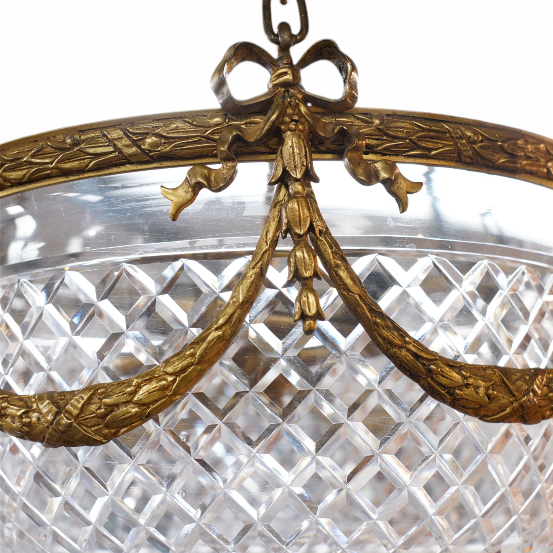 Late 20th century gilt metal ceiling light, circular form decorated with rams heads and swags, frosted glass bowl with bevelled decoration (D51cm); together with another late 20th century gilt metal ceiling ight, decorated with ribbons and rams heads with laurel swags, moulded glass bowl (D32cm)