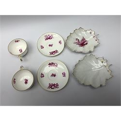 A pair of 20th century Hochst leaf formed dishes, one example with puce coloured landscape decoration, each marked beneath, L19cm, together with a pair of tea cups and saucers with printed puce fruit decoration.