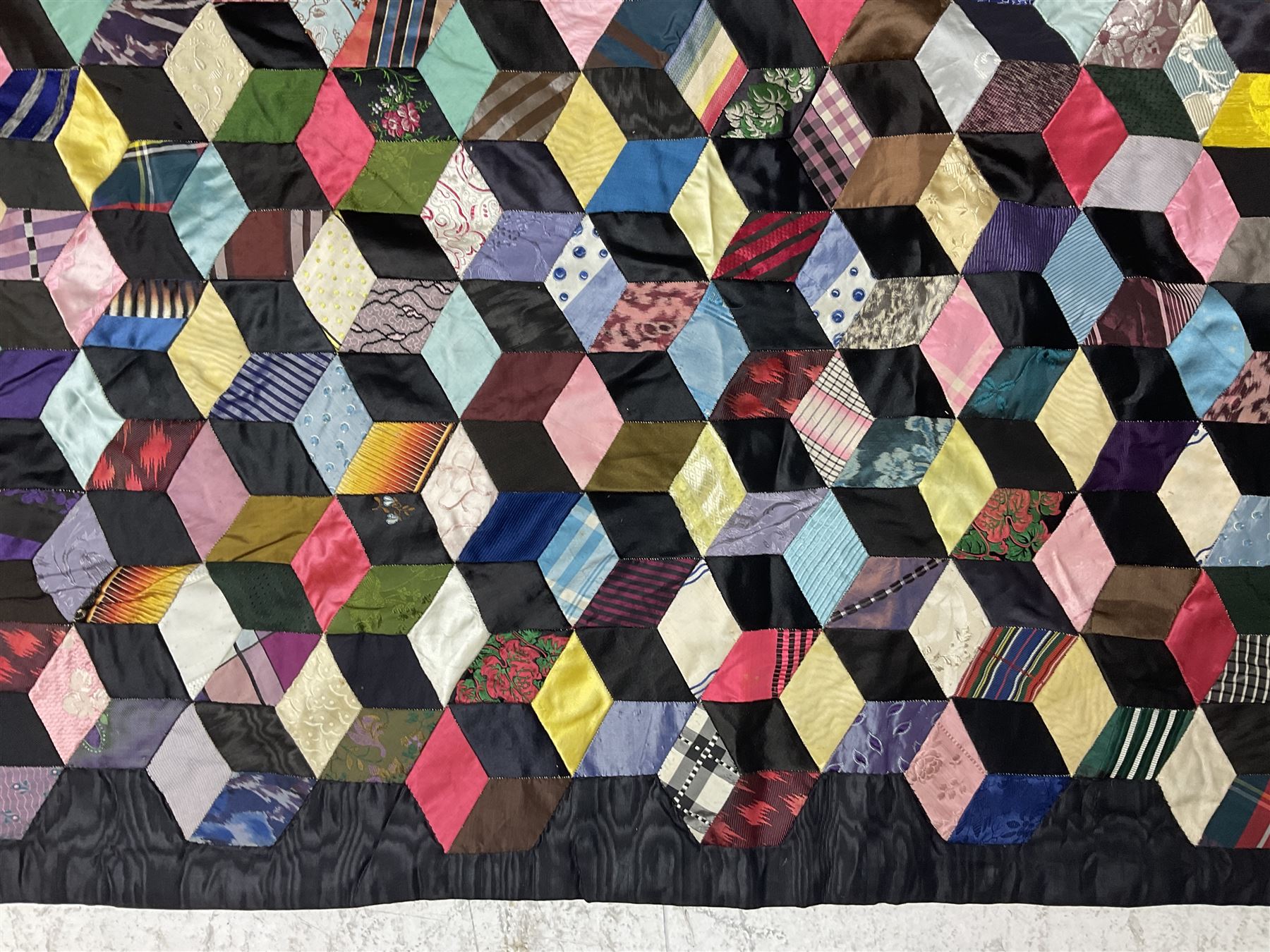 19th Century silk and satin tumbling blocks pattern patchwork quilt with black border 228cm X 196cm