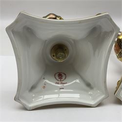 Pair of modern Royal Crown Derby Old Imari 1128 pattern candlesticks, each with shaped drip tray affixed to squat socket, upon spreading stem and canted square base with gilt dolphin edges, with printed marks beneath including Roman numeral year cypher for 2003, H26.5cm, with original boxes