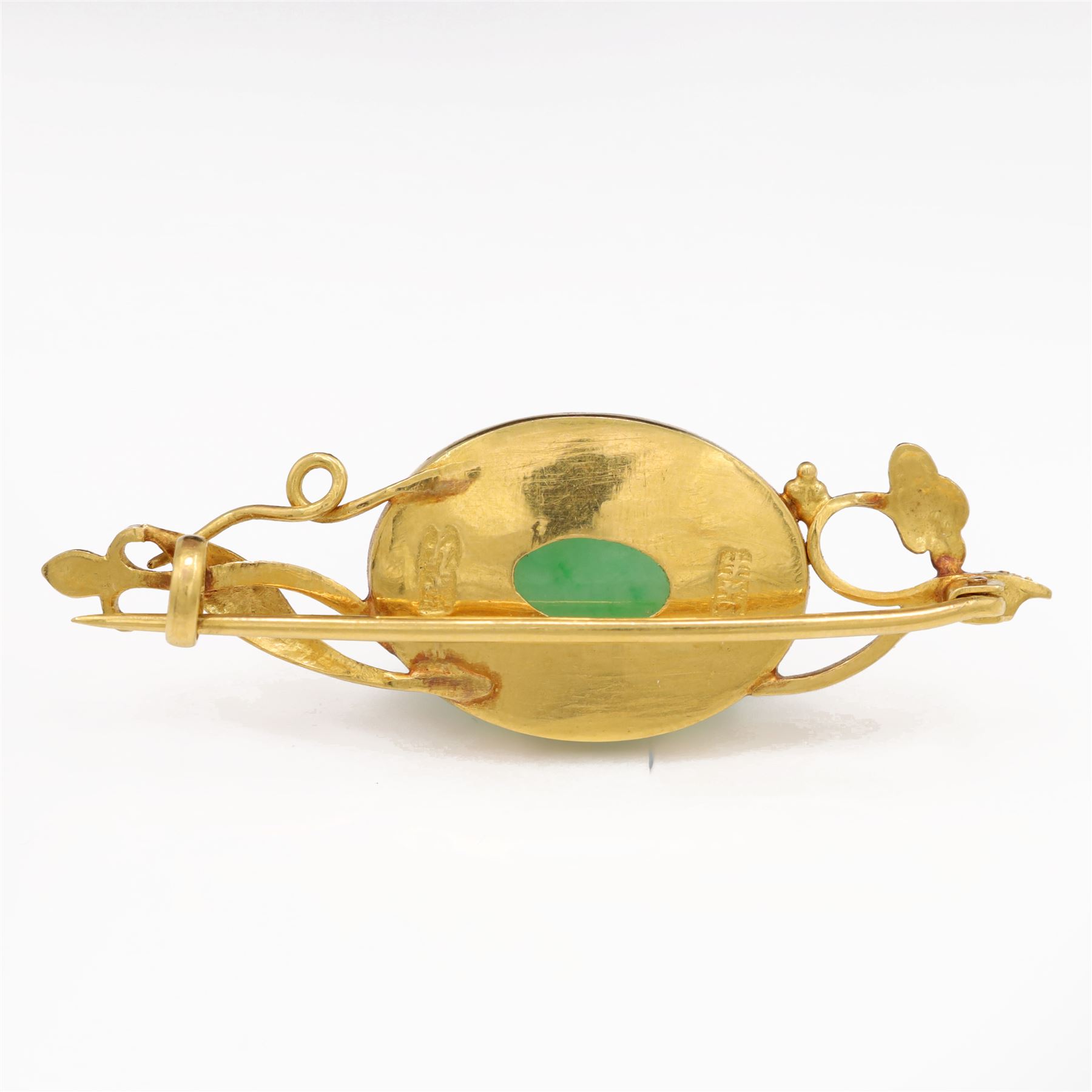 21ct gold jadeite brooch, oval cabochon cut jadeite in a floral setting