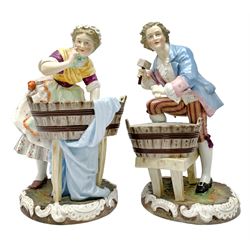 Pair of 19th century Continental porcelain figures, possibly German, modelled as a washerwoman and workman, each modelled stood over a wooden tub, upon naturalistically modelled circular base with C scroll detail, blue underglaze mark beneath, tallest example H30cm