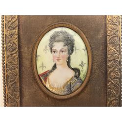 19th century portrait miniature on enamel, depicting a Georgian lady in period dress, hand painted with gilt detailing, in gilt frame with fruiting vine details, overall H13.7cm