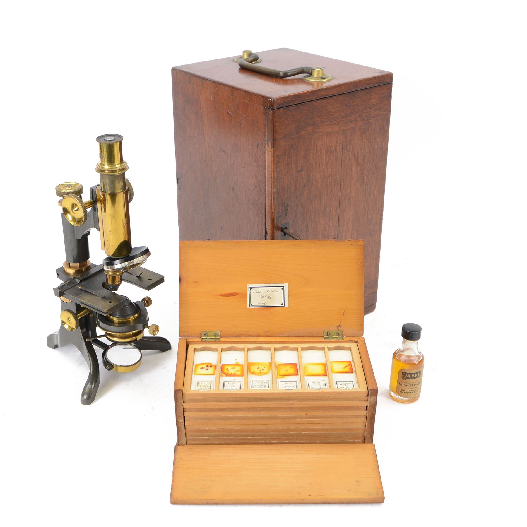 Early 20th century brass microscope, with black lacquer finish by C. E Baker of High Holborn, with lenses and plates contained within a wooden case, together with a collection of prepared microscope slides of predominantly histological and botanical specimens, contained within a wooden case