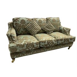 Wade - 'Kempston' three seat sofa, upholstered in chenille fabric with brocade pattern, raised on mahogany finish square tapering block feet with heavy brass castors