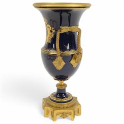 19th century Sevres style ormolu mounted porcelain twin handled urn, the body decorated with a gilt crowned crest of three fleur de lis against a cobalt ground, with spurious Sevres mark beneath, H26cm
