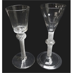  Georgian wine glass, bucket shaped bowl above a knopped air twist stem on conical foot, H15.5cm and another, pan-top bowl above a opaque twist stem with central angular knop on folded foot, H16cm (2)   