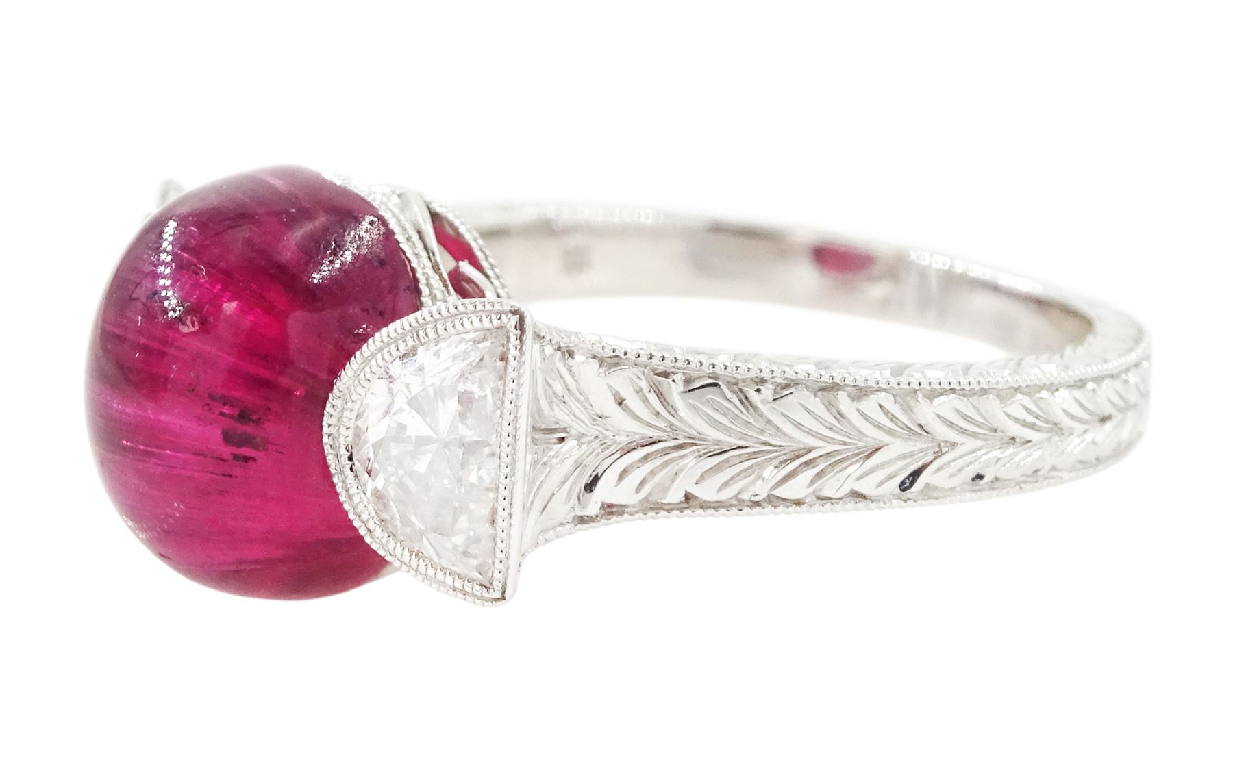 18ct white gold pink tourmaline and diamond ring, single oval cabochon cut tourmaline of approx 4.75 carat, set with a half moon cut diamond either side, to engraved laurel leaf design shoulders