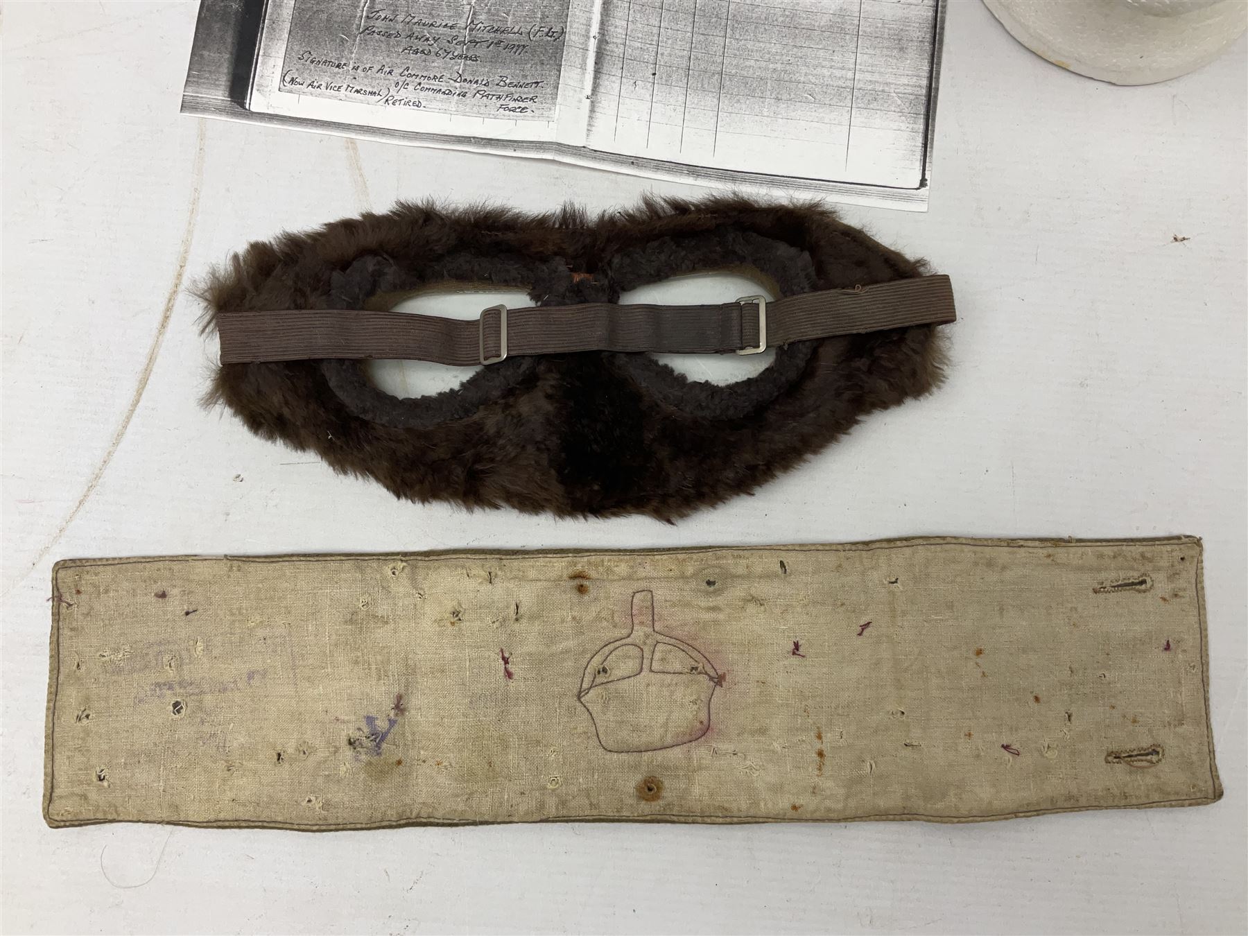 WW1 British Army Derby Scheme 1915 Attested armband; beret with East Yorkshire cap badge; pair of fur lined leather flying/motorcycle goggles; HMS Pembroke cap band; and small quantity of RNAS cloth and metal badges etc