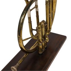 Boosey & Co Ltd French horn, converted into a table lamp, upon a wooden plinth, H45cm