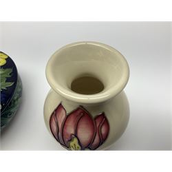 Moorcroft dish and cover, of circular form, decorated in Buttercup pattern, together with a Moorcroft vase, of baluster form, decorated in Magnolia pattern, both with printed marks beneath, tallest H9.5cm