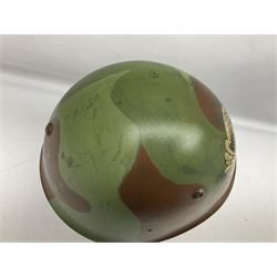 1960s Italian parachutist helmet with liner; camouflage paintwork with parachutist crest to the front