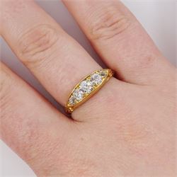Early 20th century 18ct gold five stone diamond ring, set with five graduating old cut diamonds, with scroll design shoulders, hallmarked, total diamond weight approx 0.60 carat