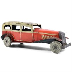 Mettoy tinplate clockwork Citroen saloon car, red orange body with cream roof and windows,...
