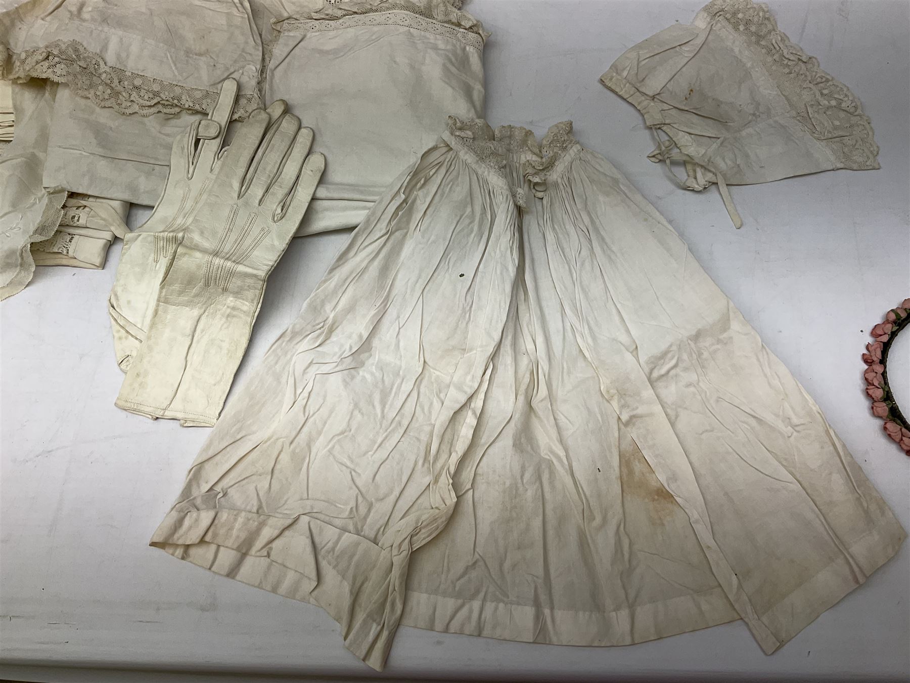 Late 18th century sampler worked with the alphabet above verses in red, by Mary Birkett aged 10 November 16th 1792, H33.5cm W34.5cm, together with another sampler worked with the alphabet above Proverbs 14:23, by Mary Anne Hainworth, Chesham, date unknown (--83), both in glazed frames, together with a quantity of Victorian and later dolls clothes to include lace examples