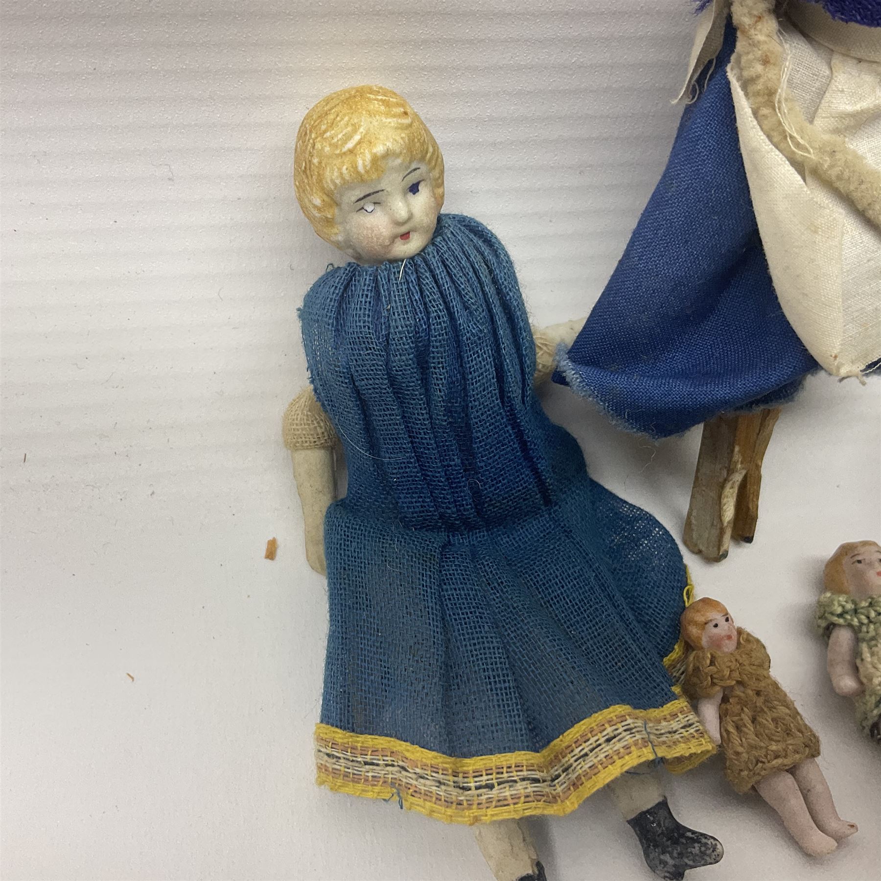Twelve miniature bisque, bisque headed and wooden dolls to include articulated examples, tallest 12cm 