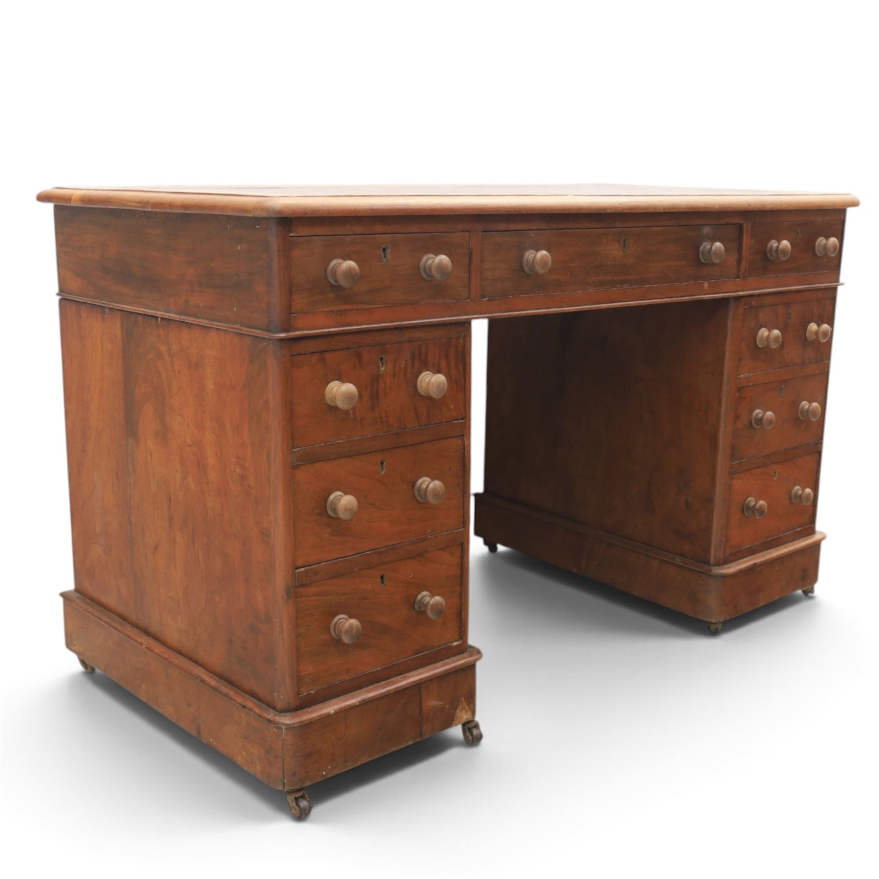 Victorian mahogany twin pedestal desk, rectangular top with red tooled leather writing surface with three frieze drawers, each pedestal with three drawers and castors