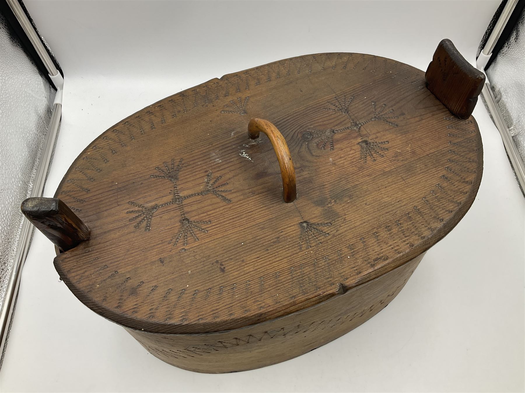 19th century Scandinavian Svepask / Tine box, the pine oval form body with notched posts and conforming lid decorated with Folk Art style pokerwork decoration and single carry handle, L38cm