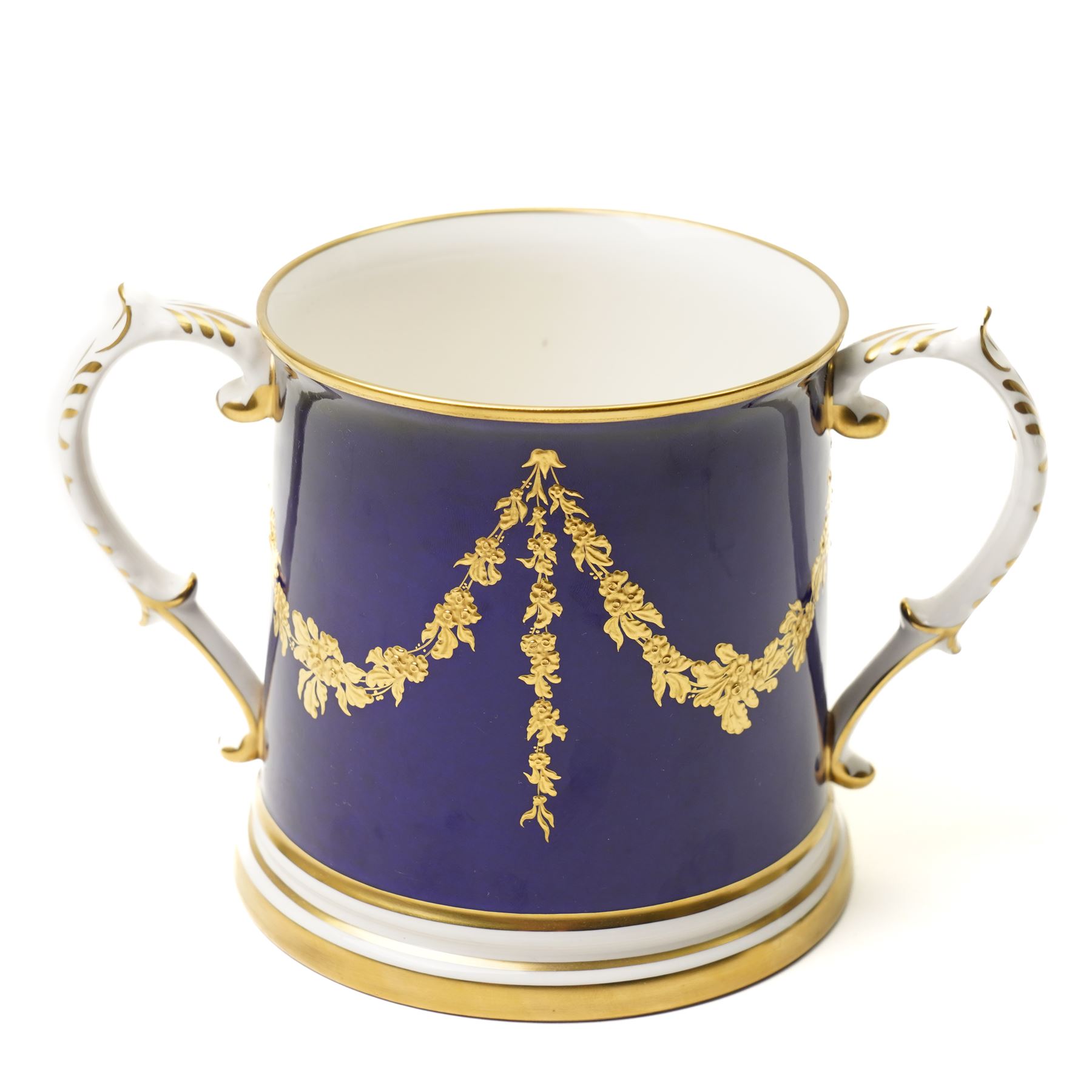 Lynton Porcelain Company loving cup, decorated with a British naval frigate, signed Stefan Nowacki, on a cobalt blue ground finely embellished in gilt enamel, printed marks to base, H11.5cm 